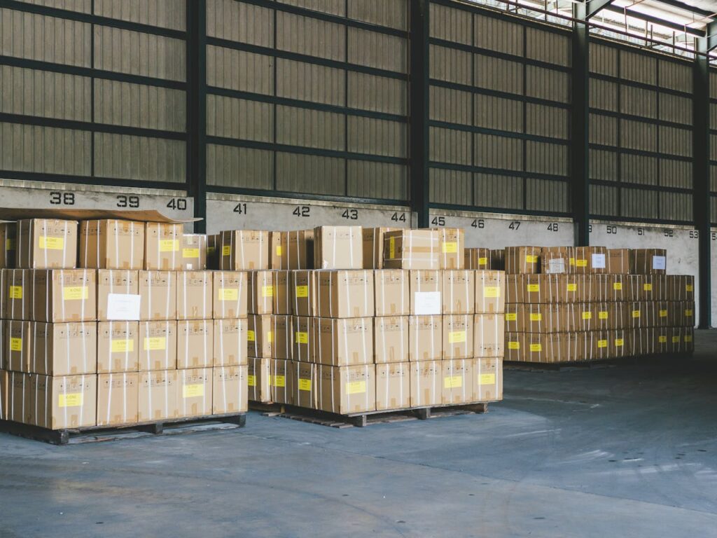 Cardboard boxes stacked on pallets in an organized warehouse in Ipoh, Malaysia.